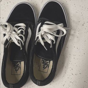 Woman’s old school black vans